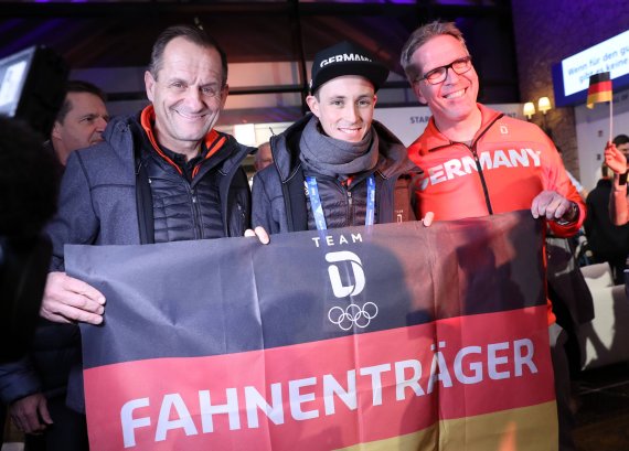 DOSB President Alfons Hörmann, flag bearer Eric Frenzel and the German Chief of Mission Dirk Schimmelpfennig at the opening of the Deutsches Haus