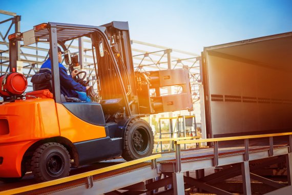 Man in forklift transporting goods