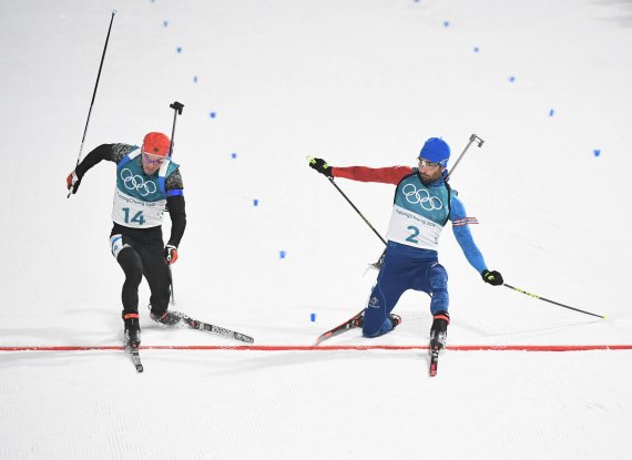 Das Foto-Finish entscheidet: Nur eine Fußspitze trennt Simon Schempp (l.) von der Gold-Medaille. Am Ende des Massenstarts über 15 Kilometer ist Martin Fourcade 18 Tausendstel Sekunden schneller (oder 14 Zentimeter weiter vorne) – und Olympiasieger. 