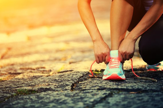 Woman ties bow in running shoe